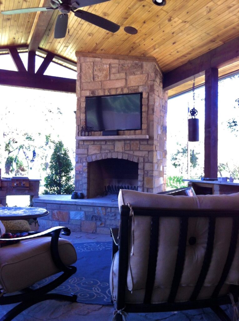 Tv installed above a fire pit outdoors