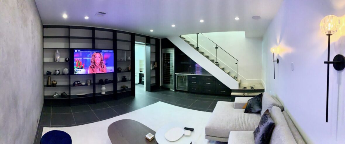 Media room with white wall's and in ceiling lighting and speakers