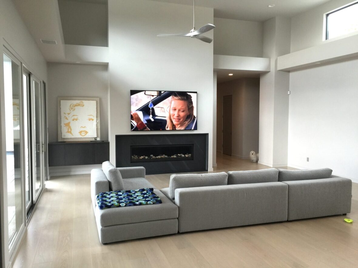 Media room mounted TV install, with Samsung framed TV mounted above fireplace with smart home automation control