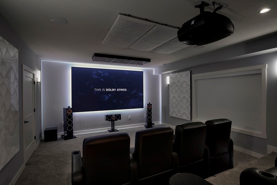Home Theater with Custom Projection displaying across 80 inch tv, Led lighting with surround sound and acoustic paneling around walls.