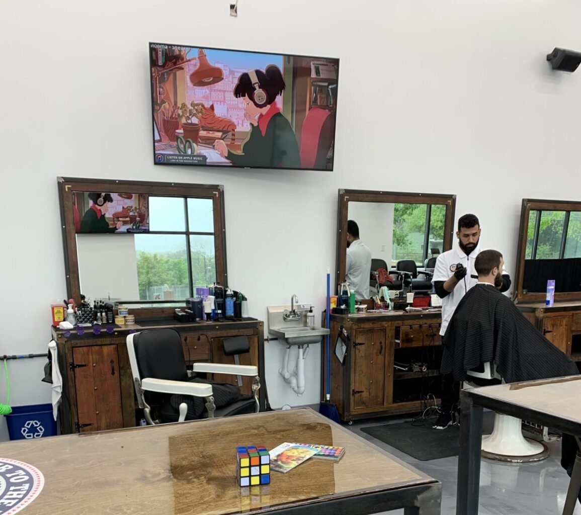 multiple mounted TVs and speakers installed throughout salon