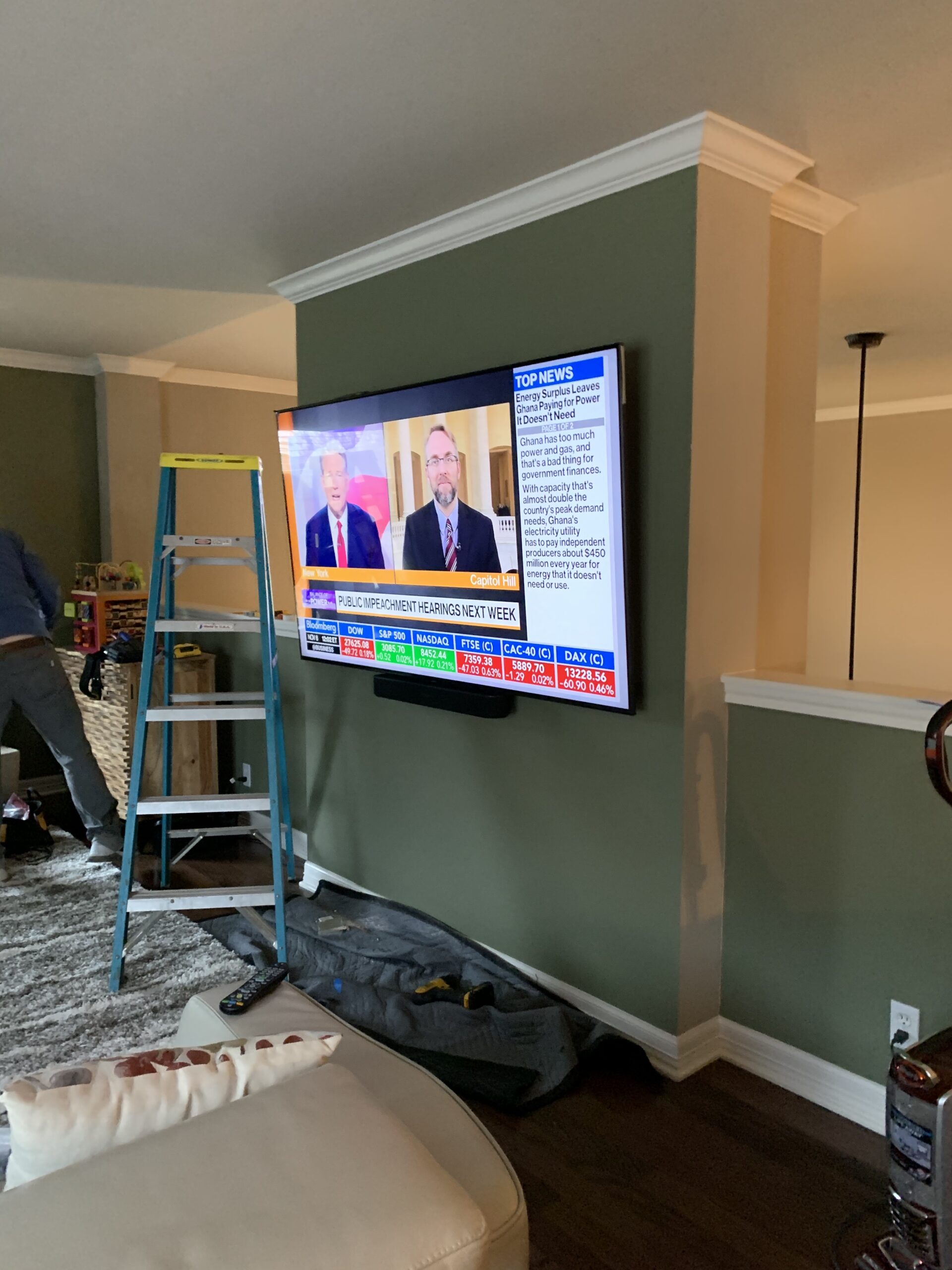 Large flat screen smart controlled TV mounted on wall