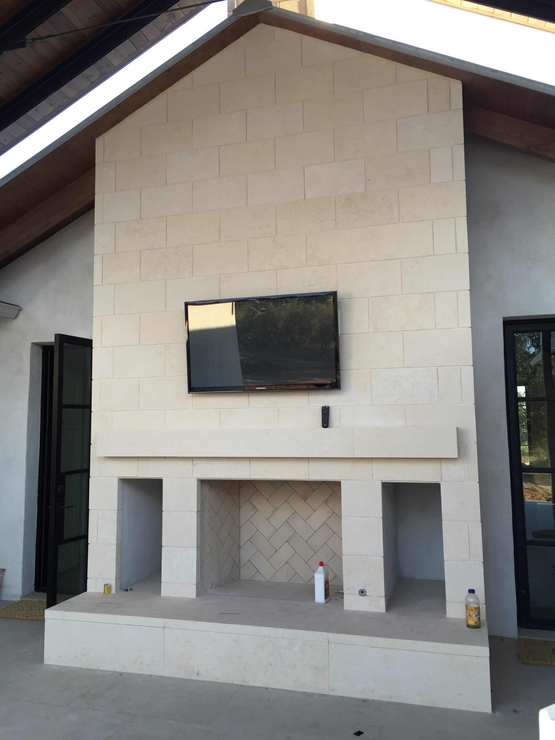 Outdoor TV installed above fireplace