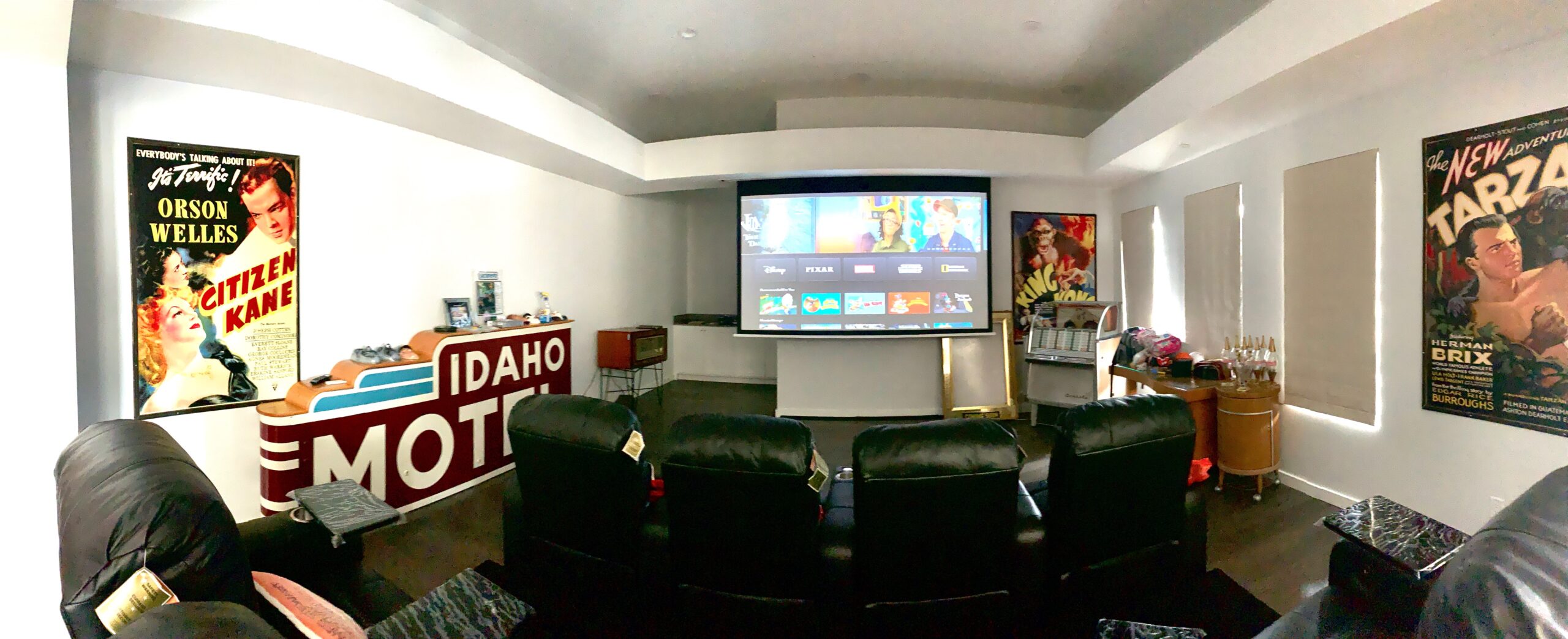 Media room retractable screen, custom leather theater seating and motorized shades