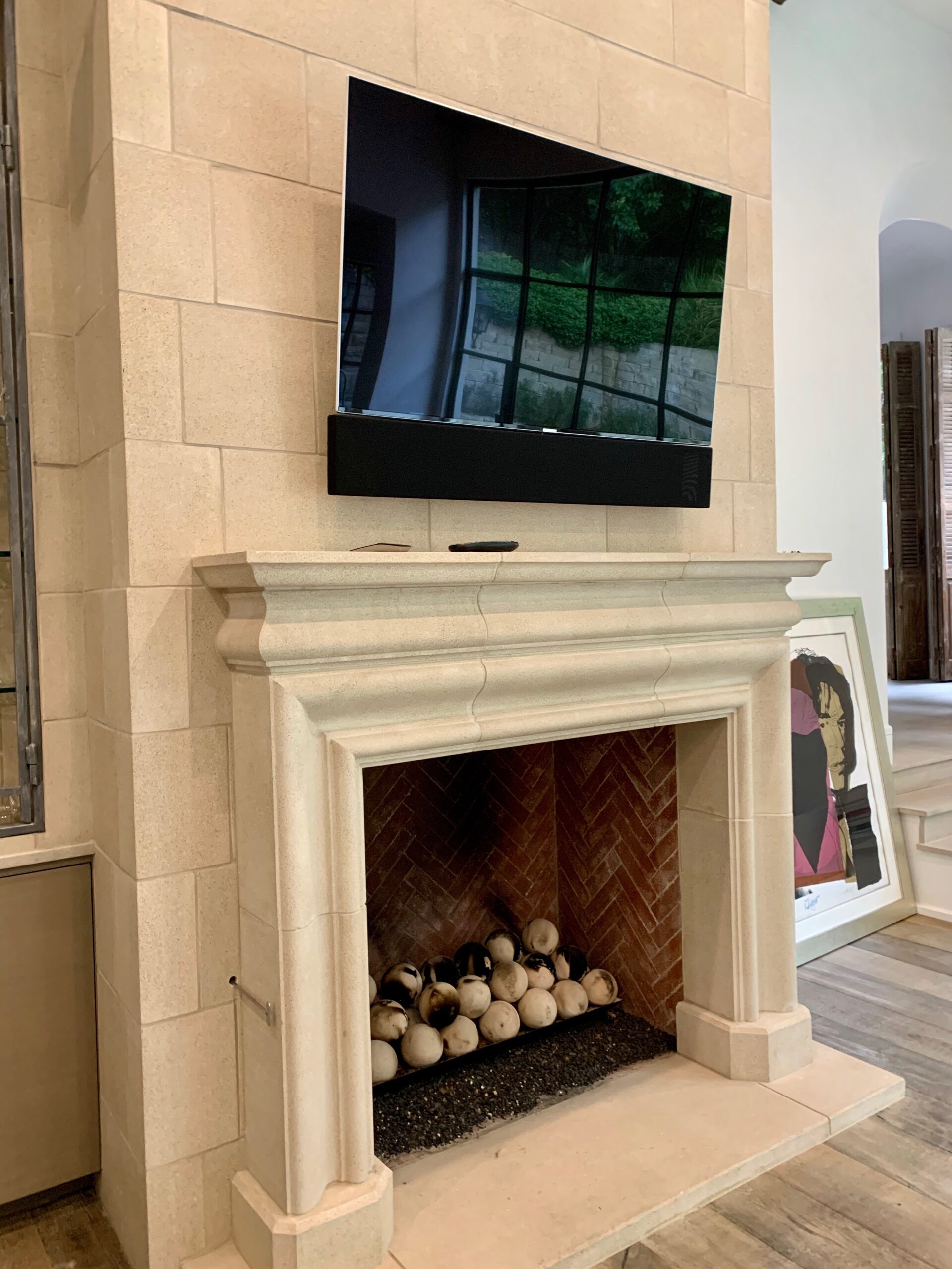Thin flat screen TV products installed above fireplace